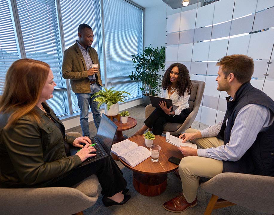 Two Biogen employees working together on a laptop in an office